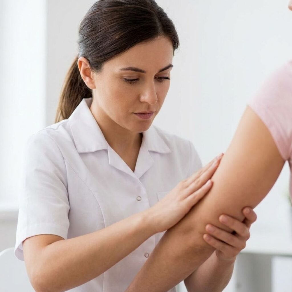 nurse looking at patient's arm